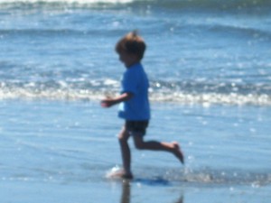 Image of child running in the surf shows hte importance of public beach access