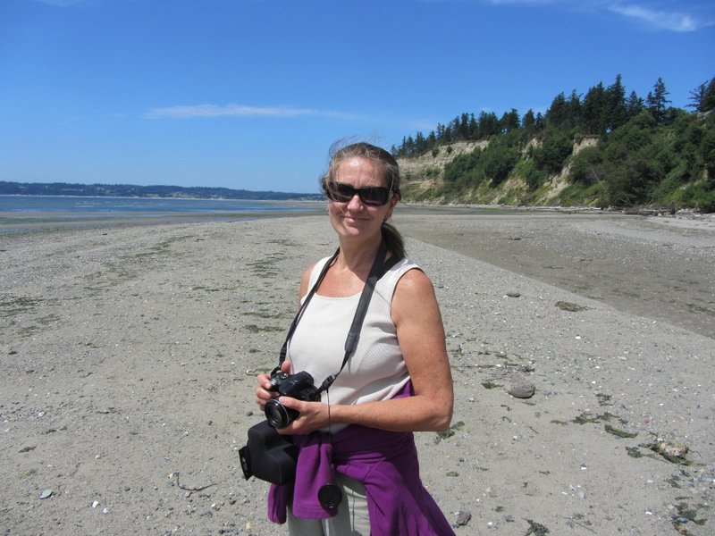 Nancy Bartlett walking the beach at Useless Bay, Whidbey Island, by Candace Allen