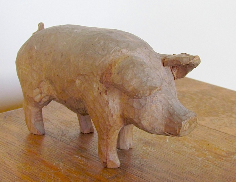 Image of hand carved wooden pig, trouble letting go