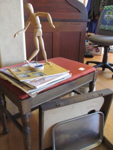 Image of artists manequin and books. Selling stuff
