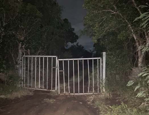 Spooky gates on dark road British Virgin Islands (BVI)