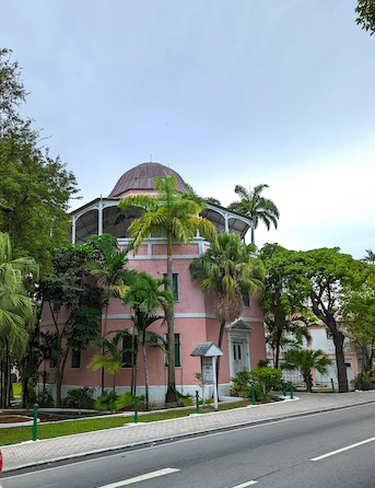 Beautiful old Nassau library. A pink octagon tower with open veranda on top.