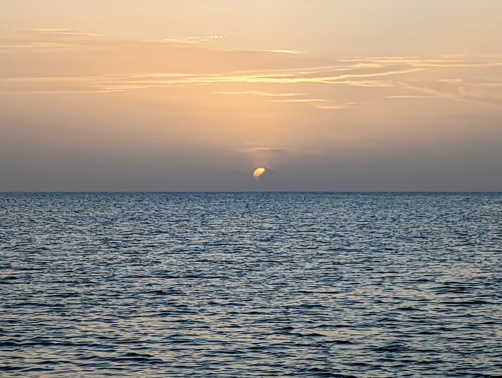 sunset at Acklin's Island, one of the Bahamas Out Islands, showing the sandy colors of Saharan dust.
